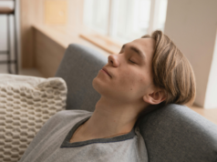 5 Simple Ways to Do a Vagus Nerve Reset at Home Young man relaxing on sofa for stress relief