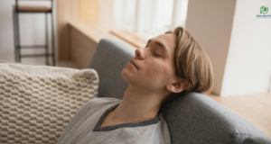 5 Simple Ways to Do a Vagus Nerve Reset at Home Young man relaxing on sofa for stress relief